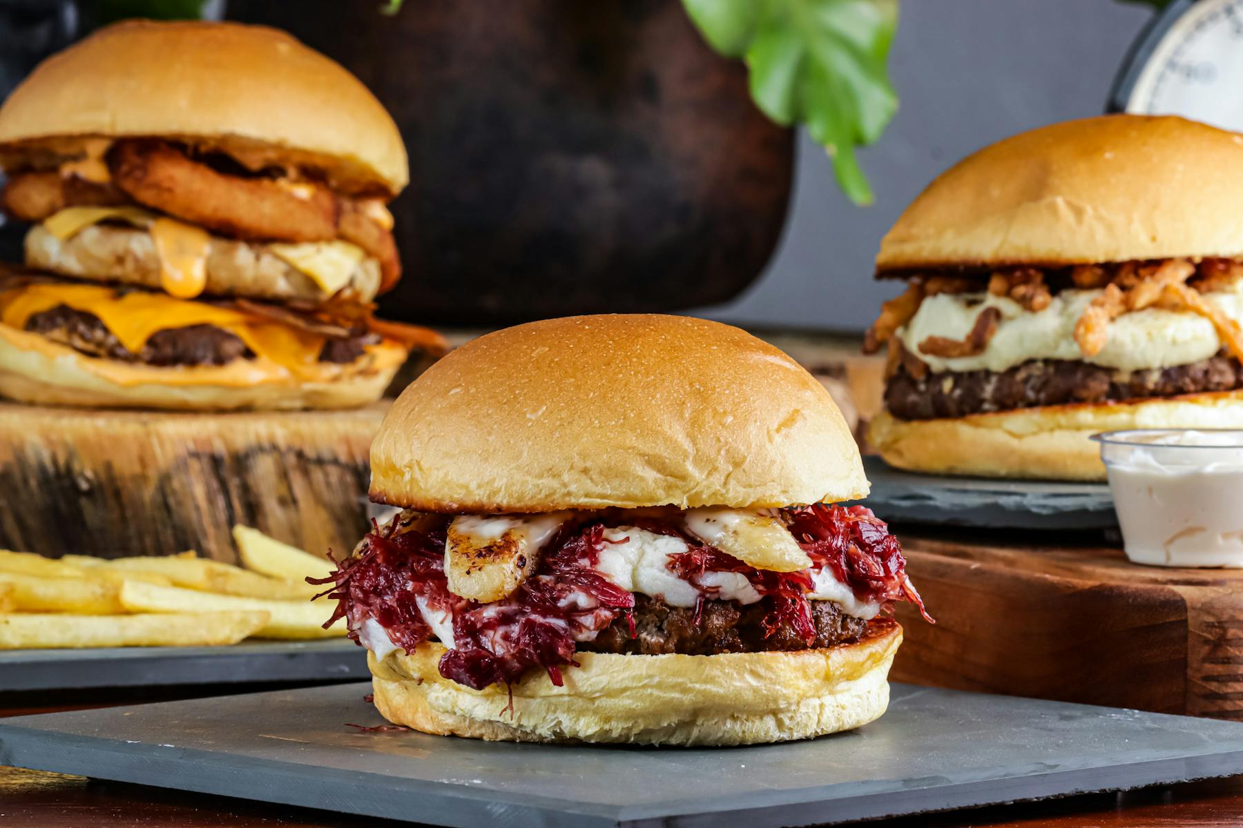 A chef preparing a burger in the kitchen, showcasing the fresh ingredients used.